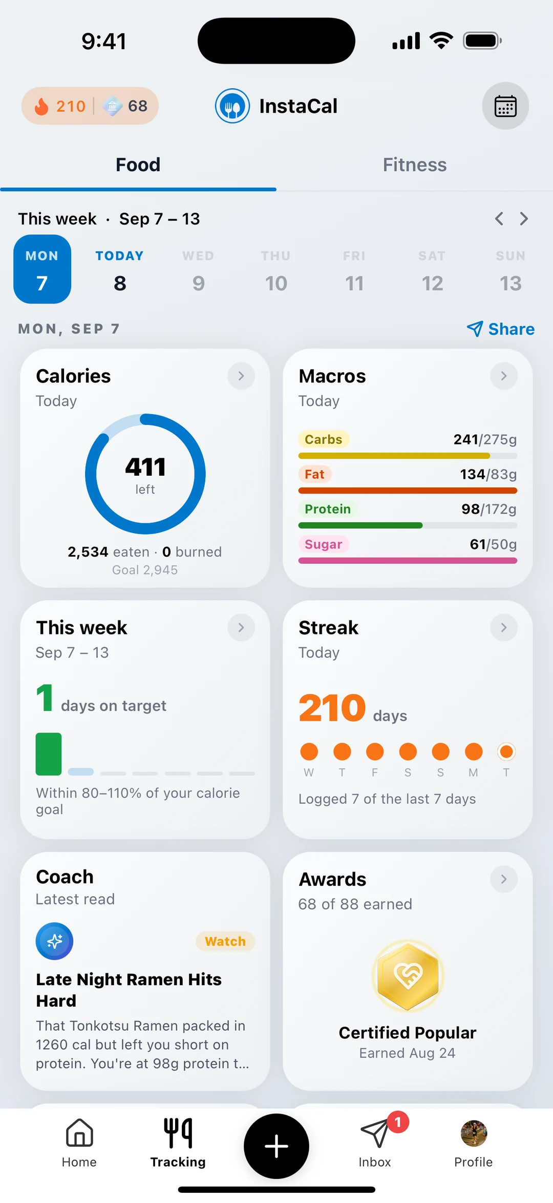 InstaCal Food tracking page: a week strip, a calories ring with 411 left, macro bars, days on target, a 210 day streak, a Coach note, and the latest award